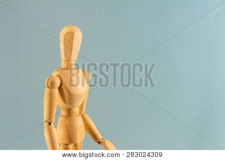 Wooden Doll As A Model For Drawing On A Neutral Background. Concept Of Asking For Help, Sadness, Lon