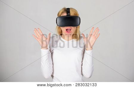 Beautiful Woman Wearing Virtual Reality Goggles In Studio. Woman Using Vr Device. Woman Enjoying Cyb
