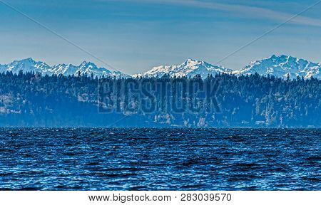 A View Of The Olympic Mounain Range Aross The Puget Sound.