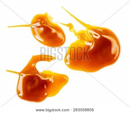 Caramel Sauce Isolated On White Background. Flowing Vanilla Toffee Sauce Top View