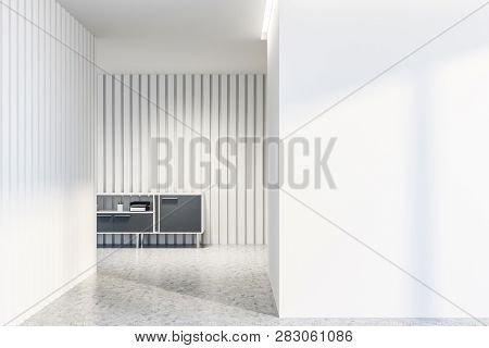 Empty White Living Room Interior With White Walls, Concrete Floor And Gray Cabinet With Folders And 