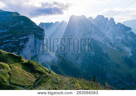 Mountain Landscape In The Swiss Alps With Jagged Peaks And A Pristine Blue Mountain Lake In The Vall