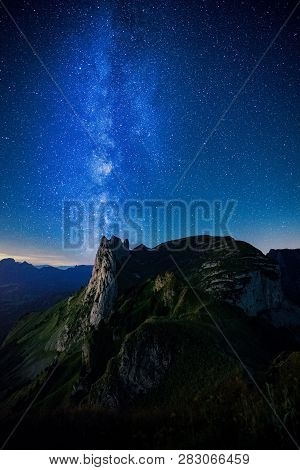 Mountain Landscape In The Swiss Alps With Jagged Peaks And A Pristine Blue Mountain Lake In The Vall