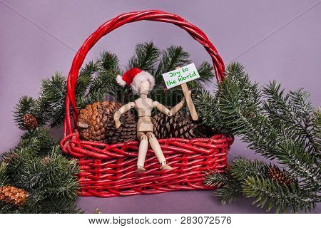 Wooden Doll Holding Season Greetings Sign Christmas Themed Large Red Basket Filled With Pinecones An