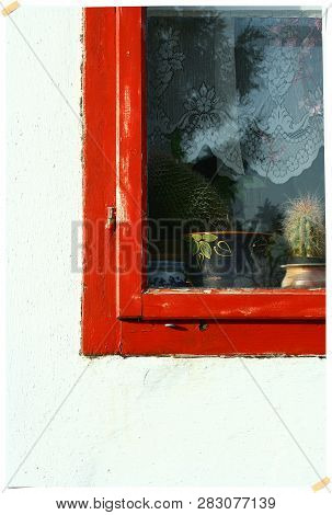 Detail Of A Window With Decorations With Red Ledge