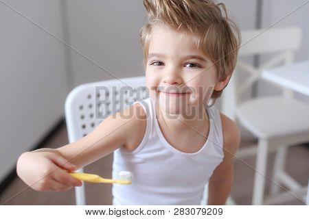 Boy Cleans His Teeth In The Morning And Plays With A Toothbrush.