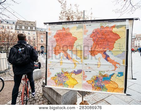Strasbourg, France - Dec 29, 2018: Young Man On Bycicle Near Das Reich Des Mittelalters The Kingdom 
