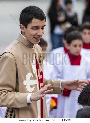 Cuenca, Ecuador - June 4, 2015 - Catholic Curate Priest Trainee Talks To Young Boys Prior To Corpus 