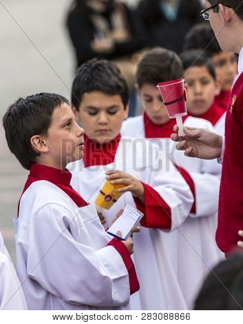 Cuenca, Ecuador - June 4, 2015 - Catholic Curate Priest Trainee Talks To Young Boys Prior To Corpus 