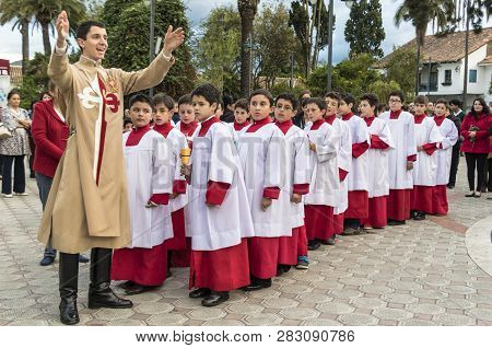 Cuenca, Ecuador - June 4, 2015 - Catholic Curate Priest Trainee Talks To Young Boys Prior To Corpus 