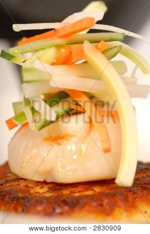 Gebratene Jakobsmuscheln mit Gemüse auf Crab Cake
