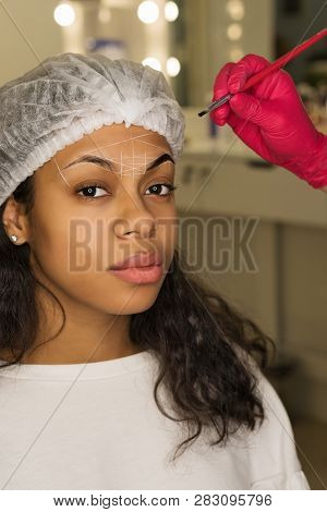 Eyebrow Shape Correction Procedure. Beauty Treatment At Spa Salon. Beautician Creates Perfect Shape 