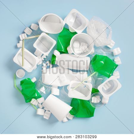 Various Plastic Garbage On The Light Blue Background, Problem Of Waste Sorting And Utilisation