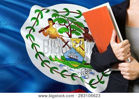 Learning Belizean Language Concept. Young Woman Standing With The Belize Flag In The Background. Tea