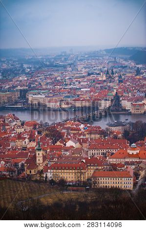 View Of The Red Roofs, Vltava And Bridges In Prague. Stare Misto And Mala Strana. Overcast Weather