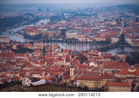 View Of The Red Roofs, Vltava And Bridges In Prague. Stare Misto And Mala Strana. Overcast Weather