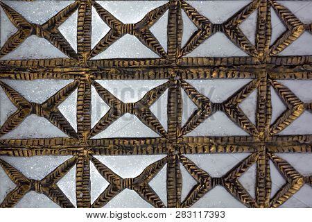 Old Carved Wooden Latticework With Flowers And Squares Design Creating A Perforated Wall.