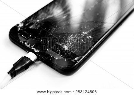 Cell Phone With The Screen Broken By A Hammer. Non-warranty Repairs Concept.