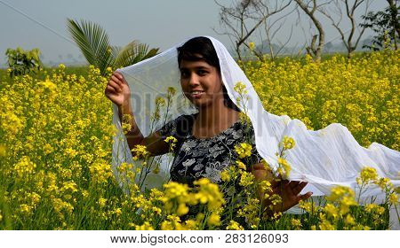 Close Up Of A Laughing Girl Wearing A Blue Salwar And Covering Her Dead With A White Cloth In  Rapes