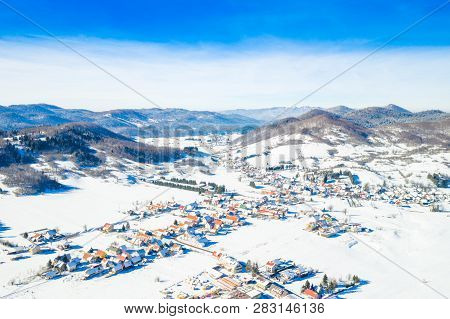 Croatian Countryside Landscape In Winter, Panoramic View Of Small Town Of Mrkopalj Under Snow In Gor
