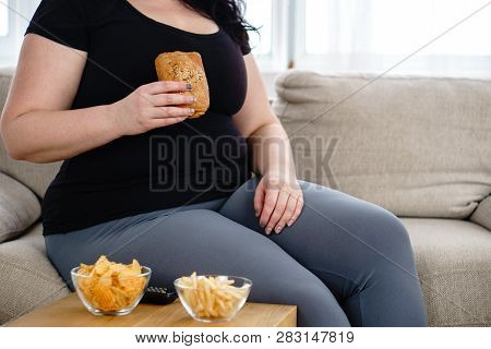 Lack Of Physical Activity, Imbalanced Nutrition, Laziness, Homebody. Lonely Fat Woman Watching Serie