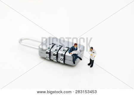 Miniature People Are Decrypting Unlock Padlock, Decrypt The Key. Concept For Data Security Breach, R