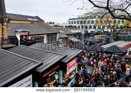 LONDON, UK - DECEMBER 30, 2018: Visitors at Camden Lock. Camden Lock, Camden Market, and streets nearby are the fourth-most popular attraction in the city, attracting 100,000 people each weekend
