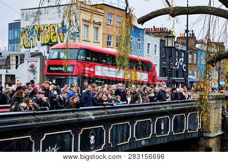 LONDON, UK - DECEMBER 30, 2018: Visitors at Camden Lock. Camden Lock, Camden Market, and streets nearby are the fourth-most popular attraction in the city, attracting 100,000 people each weekend