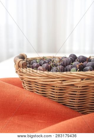 Agrus In A Basket On The Background Of A Linen Tablecloth