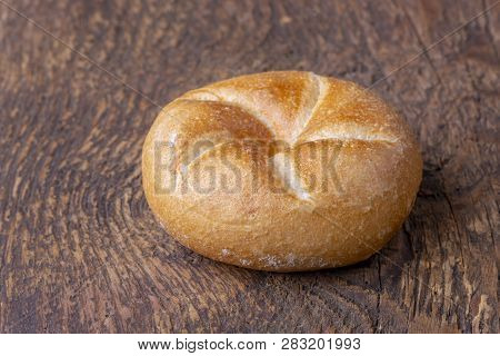 Closeup Of A Single Bavarian Bun On Wood