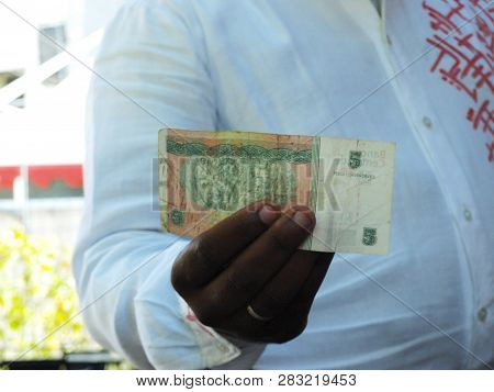 Havana, Cuba - June 21, 2018: Waiter Holding A Cuban Peso Banknote