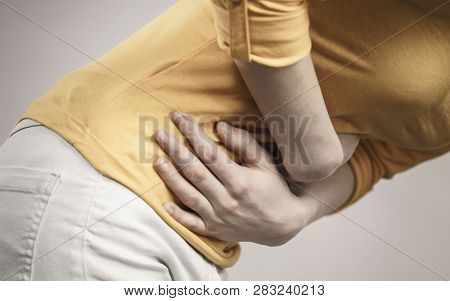 Health Care Concept. Bellyache, Indigestion Or Menstruation. Young Unrecognizable Female Suffering F