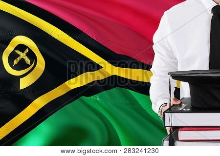 Successful Student Education Concept. Holding Books And Graduation Cap Over Vanuatu Flag Background.