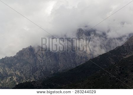 Mountains With Clouds In Central Corsica, France.