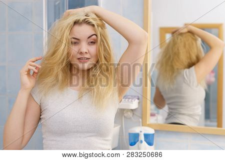 Young Blonde Female Feeling Dull And Tired After Waking Up. Woman Yawning Being Sleepy In Bathroom.