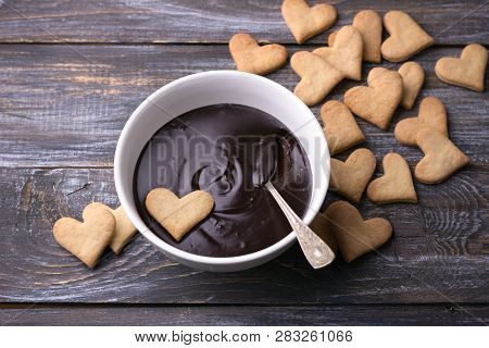 Bowl Of Delicious Chocolate Mousse And Heart Cookies For Valentine's Day On Wooden Background
