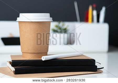 Coffee Cup On Notebook At Modern Office Stationery On White Table And Dark Grey Wall.pencil,ruler,pe