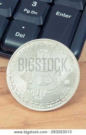 Silver Bitcoin And Compuer Keyboard, Symbol Of Electronic Virtual Money And Mining Cryptocurrency Co