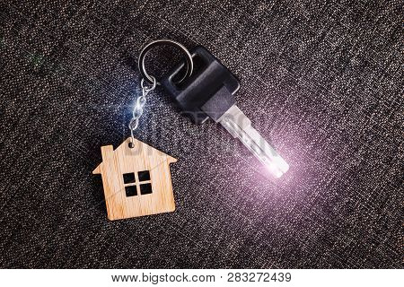 House Shaped Key Ring Resting On The Carpet For The Home Or Rental Property. House Key Shining Brigh