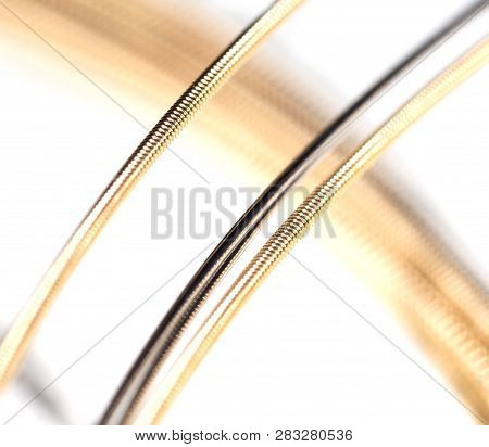 Strings For Guitar Isolated On A White Background. Macro