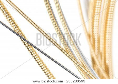 Strings For Guitar Isolated On A White Background. Macro