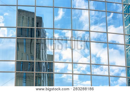 Abstract Architecture Background. Sky And Buildings Are Reflected In The Office Skyscraper Facade. C