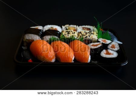 Close Up Top View Mix Sushi With Various Ingrediant As Salmon, Tuna, Avocado,sesame On Black Backgro