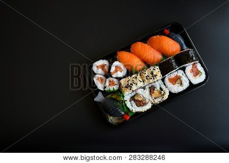 Close Up Top View Mix Sushi With Various Ingrediant As Salmon, Tuna, Avocado,sesame On Black Backgro