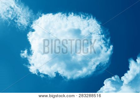 Fluffy Round Cloud In Clear Blue Sky. Peaceful Cloudy Sky Natural Background, Frame. Divine Shining 