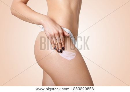 Wellness, Wellbeing, Vitality Concept. Sideways Shot Of Slim Woman Applies Cream On Hip, Has Flawles