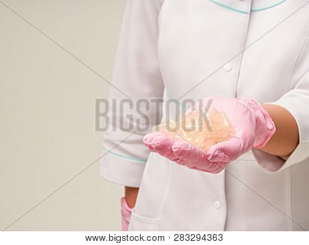 Placebo Effect Concept. Doctors Hand Giving A Heap Of Empty Pills Capsules With Placebo Effect On Wh