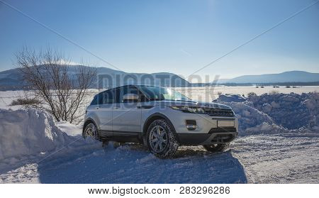 White Range Rover Evoque With A Black Roof On A Winter Road On The Background Of Zhiguli Mountains O