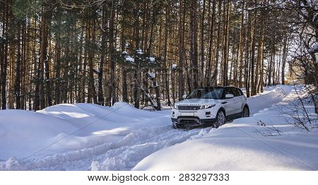 White Range Rover Evoque With A Black Roof On A Winter Road In The Forest Of The Samara Region, Russ