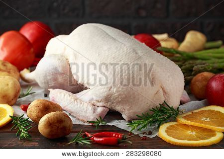 Raw Duck On Baking Paper With Variety Of Vegetables